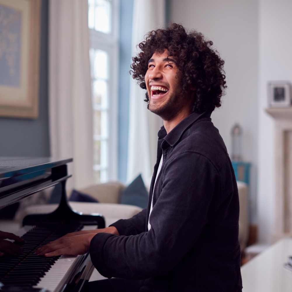 Man Happily Playing Piano.jpg