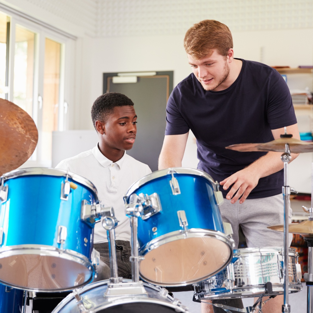 Man Teaching Drums To Boy.jpg