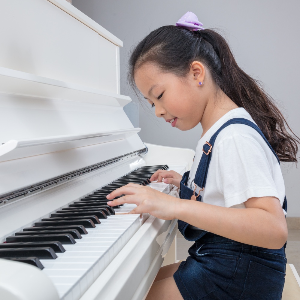 Young Asian Girl Playing Piano.jpg